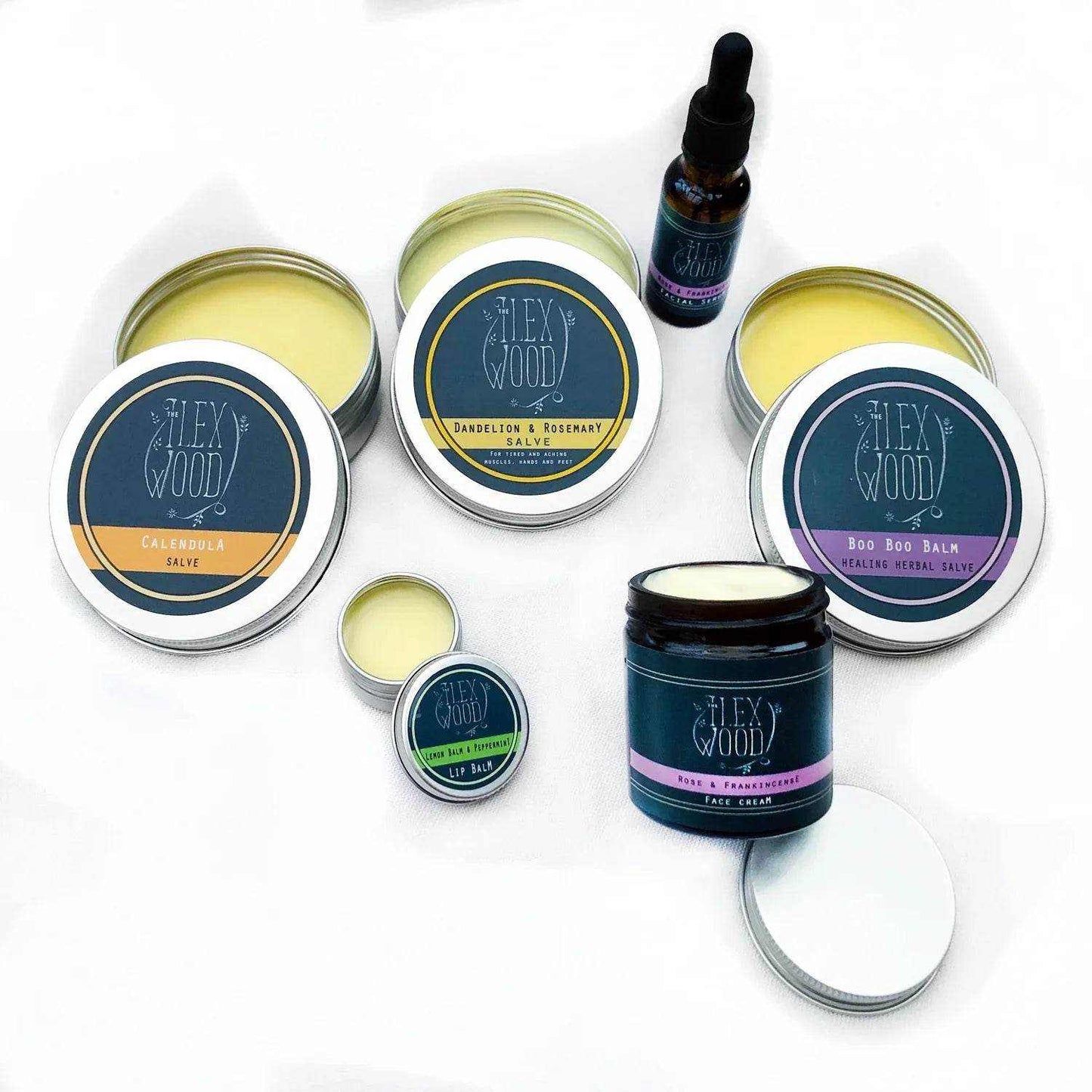 Handcrafted natural beauty gift box with six varieties of skincare products including salves, face cream, serum, and lip balm in eco-friendly packaging